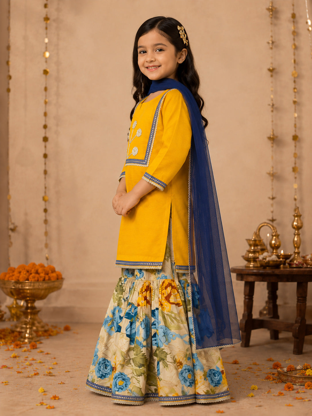 Bitiya By Bhama Girls Mustard Kurta With floral Printed Sharara And Blue Dupatta.