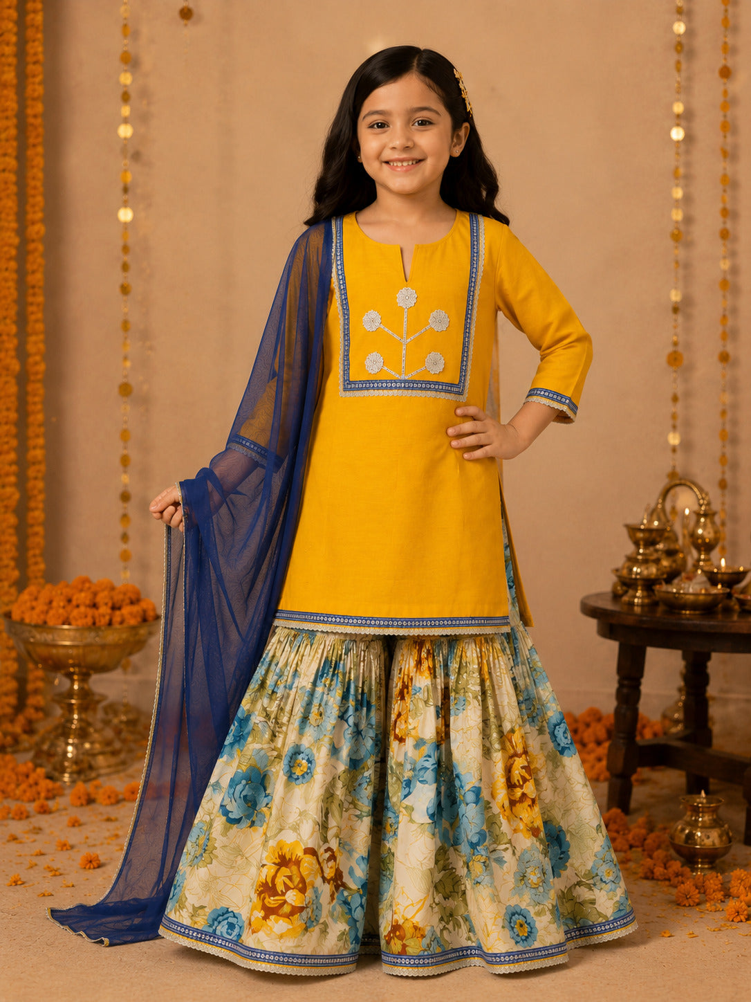 Bitiya By Bhama Girls Mustard Kurta With floral Printed Sharara And Blue Dupatta.