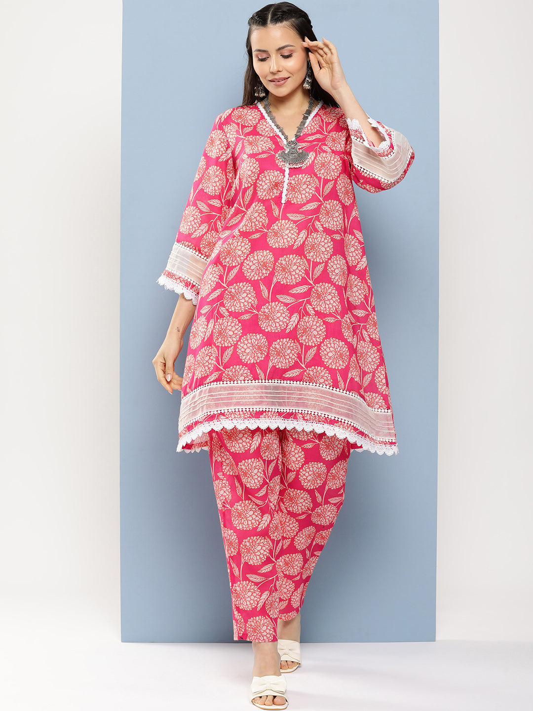 Bhama Couture Pink Floral Print A- Line Kurta With Lace Detailing & Pink Floral Print Trousers.